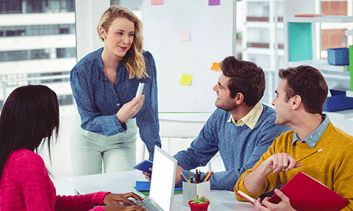 young-female-boss-talking-to-her-team-about-performance-management.png